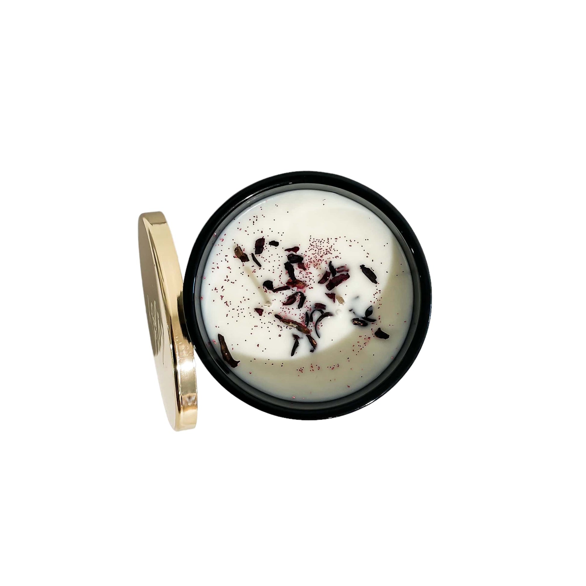 A top down view of a black jar 16oz soy candle with a sprinkle of hibiscus flowers and pink glitter on the wax and a gold lid and a white label named Mom's in a Mood, on a white background, made by Ebony & Ivory Candle Co in Lethbridge, Alberta, Canada