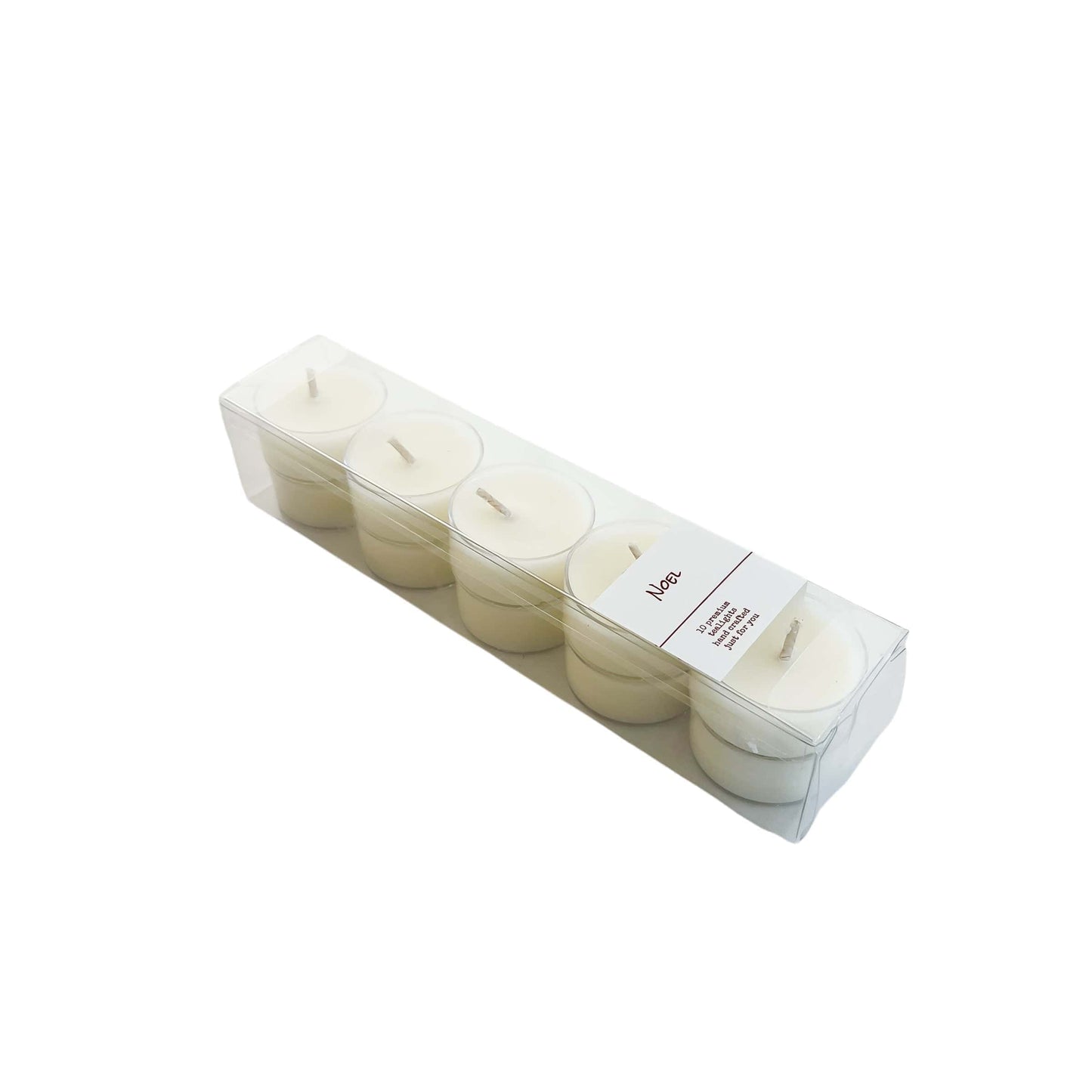 A clear box of 10 soy tea lights with a white label named Noel, on a white background, made by Ebony & Ivory Candle Co in Lethbridge, Alberta, Canada
