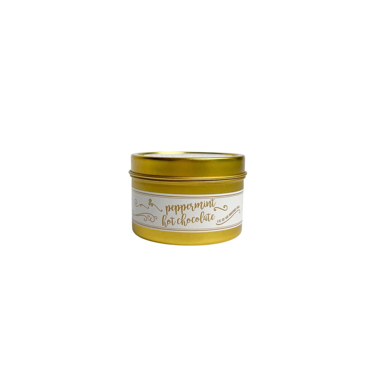 A gold 4oz soy christmas candle with a white and gold label named "peppermint hot chocolate"