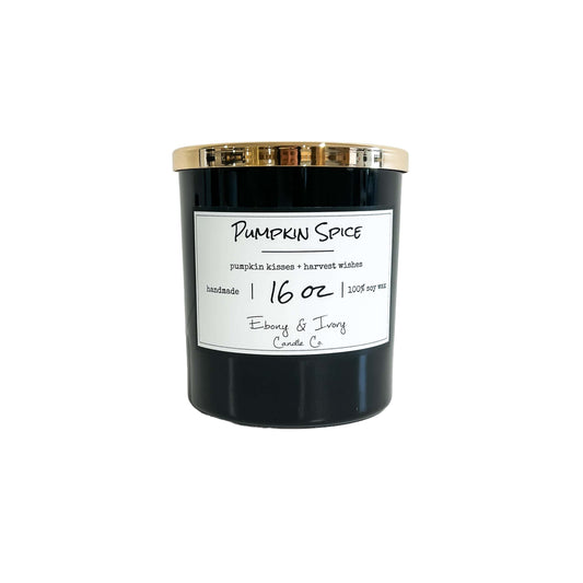 a Black 16 oz soy candle with a gold lid and white label named "pumpkin Spice" on a white background