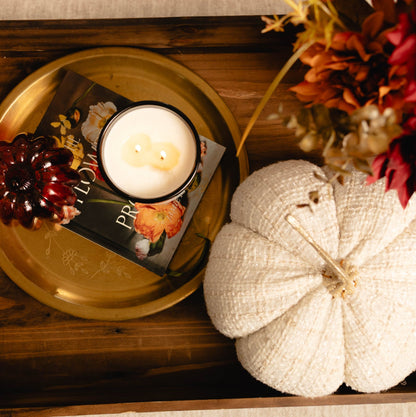 Decorative tray with a candle, pumpkin, and fall-themed decor on a textured surface. Pumpkin Spice soy fall candle Alberta Canada.