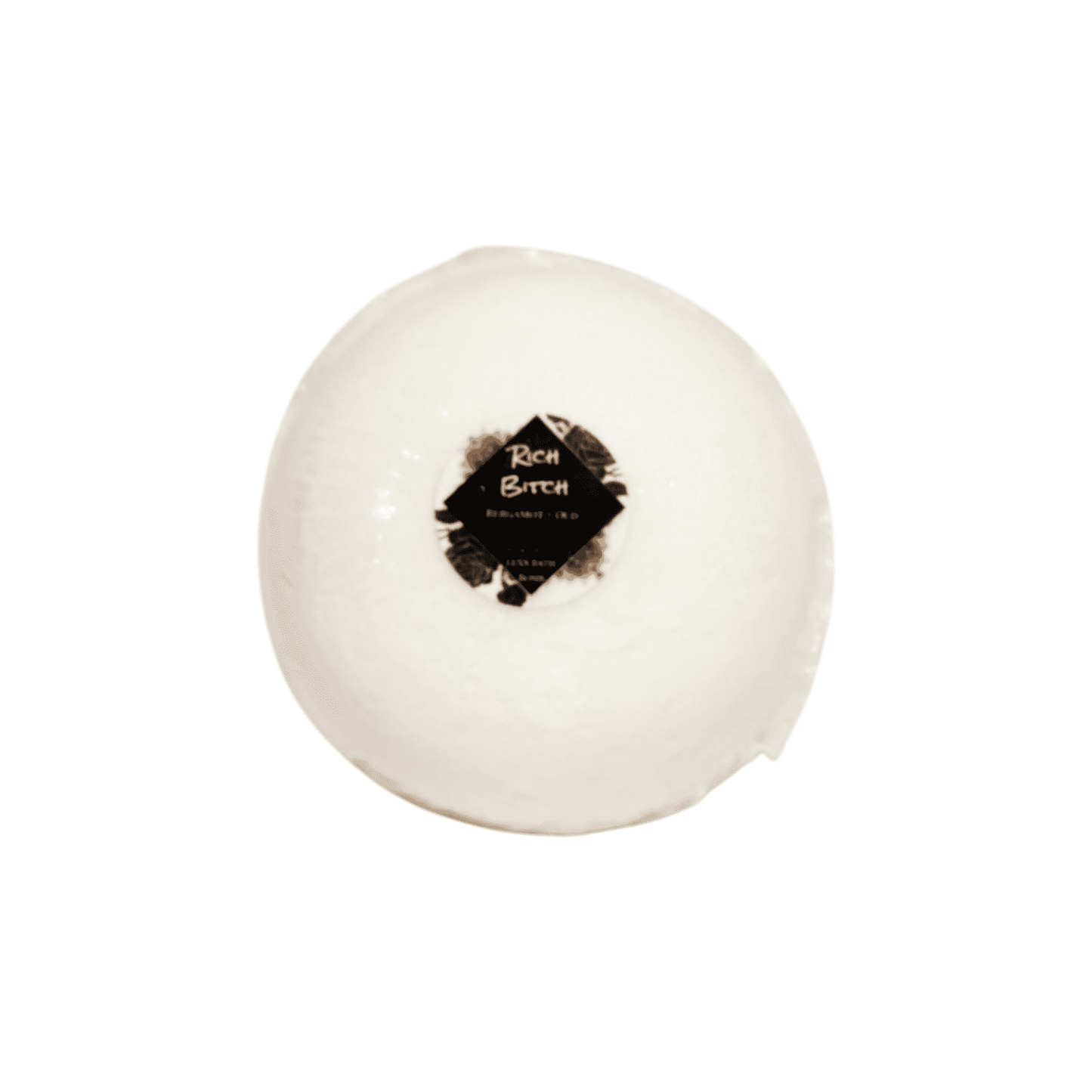 A white bath bomb with a round sticker label named Rich Bitch, on a white background, made by Ebony & Ivory Candle co in Lethbridge, Alberta, Canada