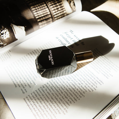 Perfume bottle on an open book with a blurred background