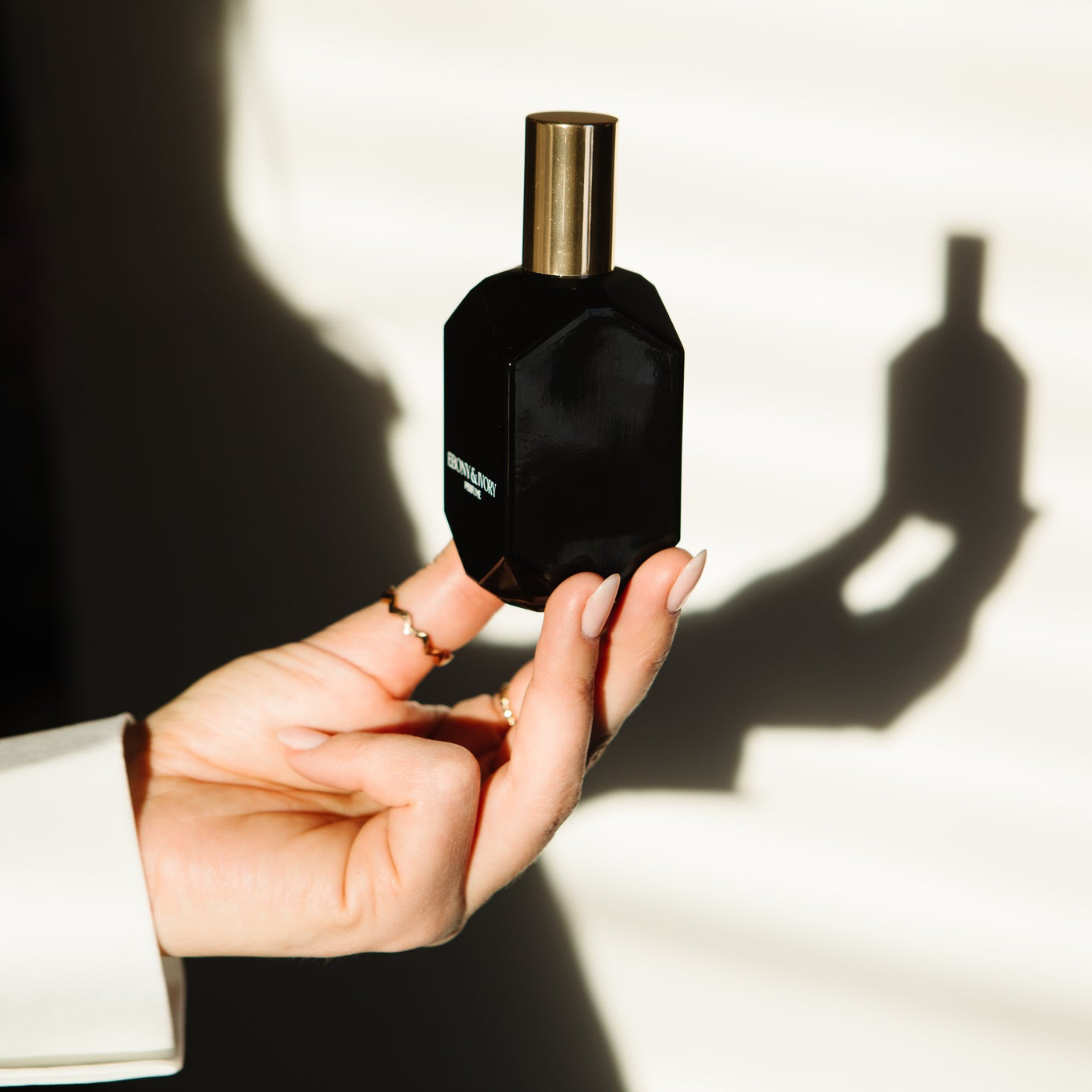 Woman holding Saint perfume warm sensual gourmand fragrance