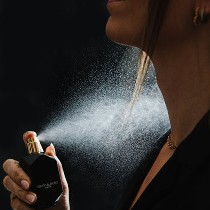 Woman holding Saint perfume warm sensual gourmand fragrance