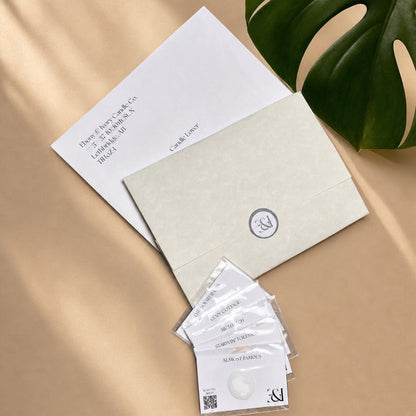 Product packaging with cards and leaf on a beige surface scent sampling experience papers, envelope and scent samples