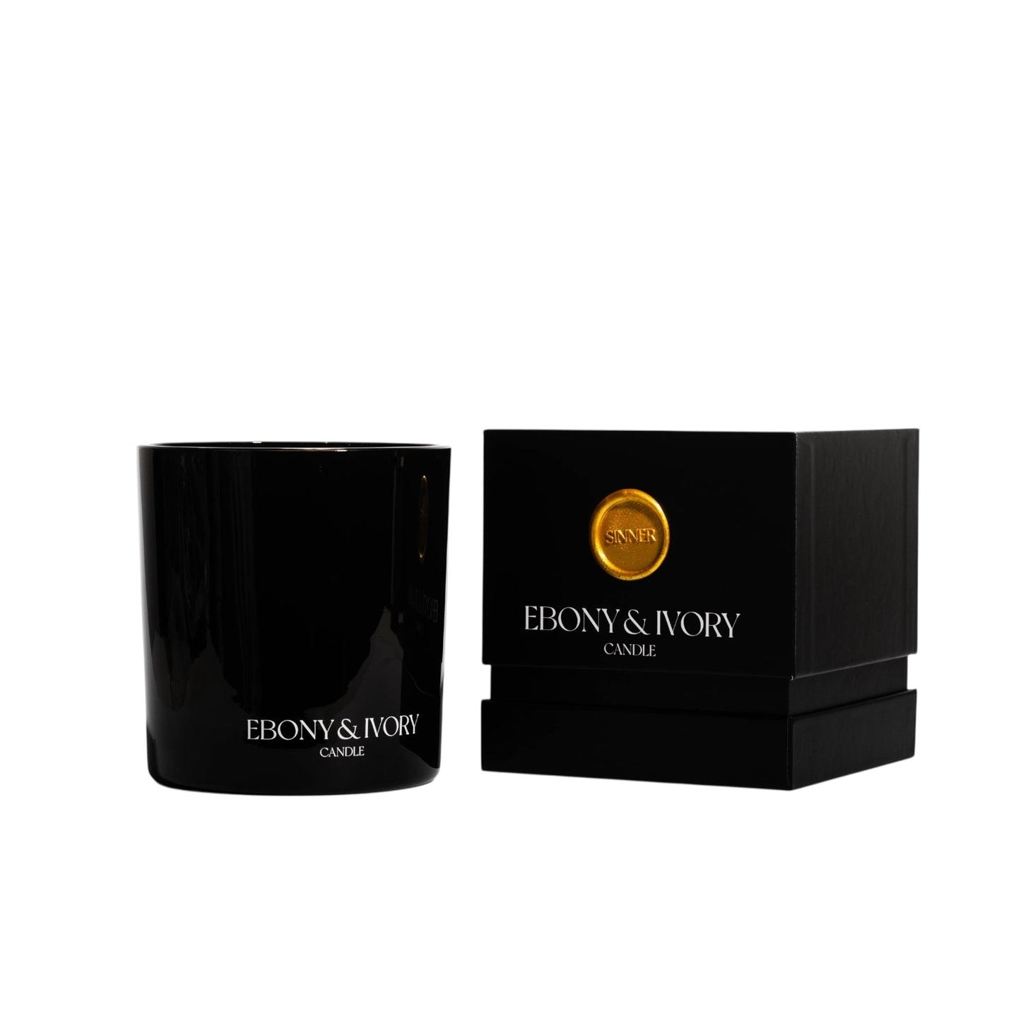 A black 18oz jar coconut soy candle with a white Ebony & Ivory on the front next to a black candle box with a gold label named Sinner, on a white background, made by Ebony & Ivory Candle Co in Lethbridge, Alberta, Canada
