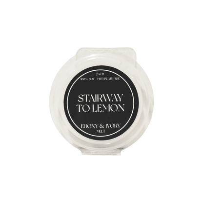 A clear 2.5oz clamshell scented soy wax melt with a black label named Stairway to Lemon, on a white background, made by Ebony & Ivory Candle Co in Lethbridge, Alberta Canada