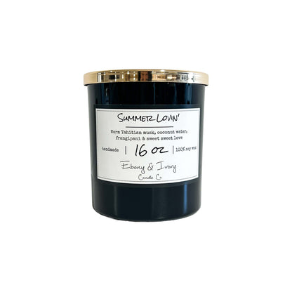 A black 16oz soy candle with a gold lid labelled Summer Lovin, on a white background. Made in Lethbridge, Alberta, Canada