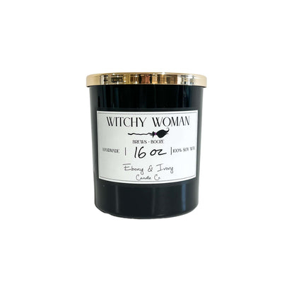 A black 16oz soy candle with a gold label and a white label named Witchy Woman