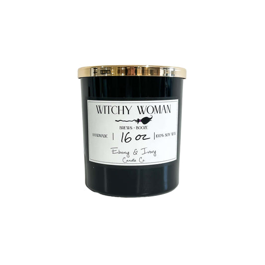 A black 16oz soy candle with a gold label and a white label named Witchy Woman