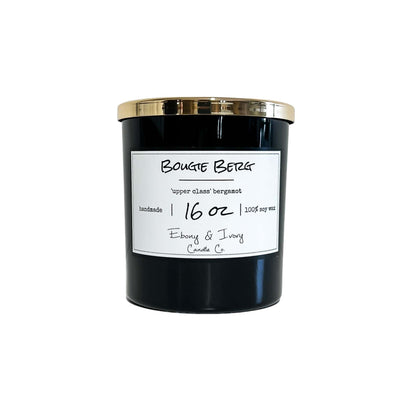 A black 16oz jar soy candle with a gold lid and a white label named Bougie Berg, on a white background, made by Ebony & Ivory Candle Co in Lethbridge, Alberta, Canada