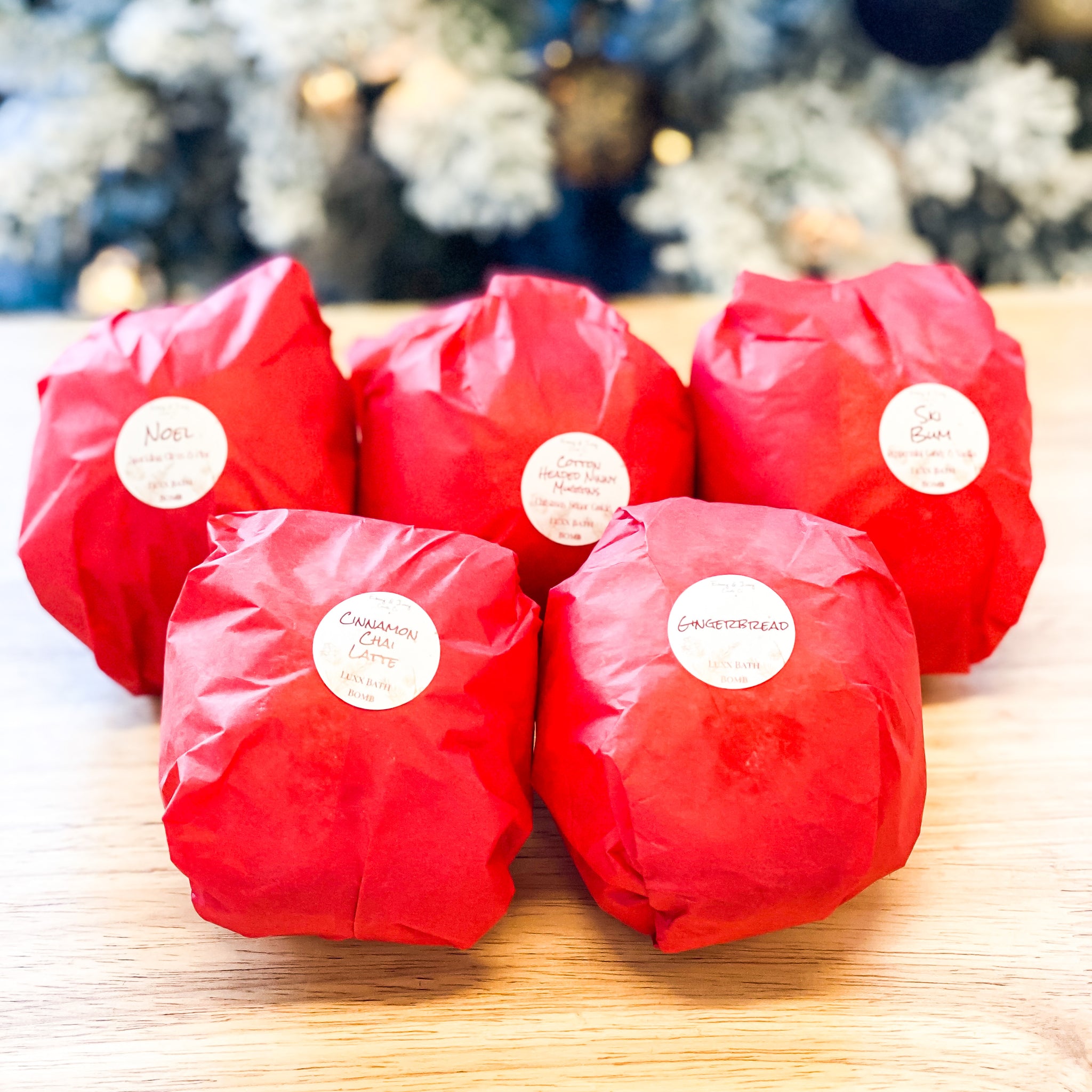 five red, holiday scented, bath bombs