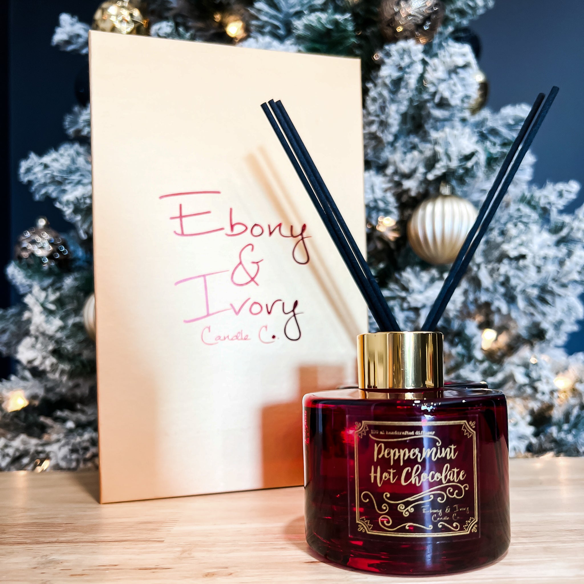Red, one hundred milliliter, peppermint hot chocolate and sweet creamscented reed diffuser with a gold lid and label