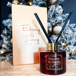 Red, one hundred milliliter, peppermint hot chocolate and sweet creamscented reed diffuser with a gold lid and label