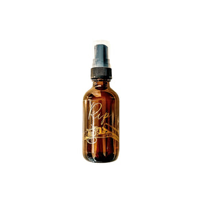 Amber, two fluid ounce, apple and bourbon scented fragrance spray labeled Rip in gold letters