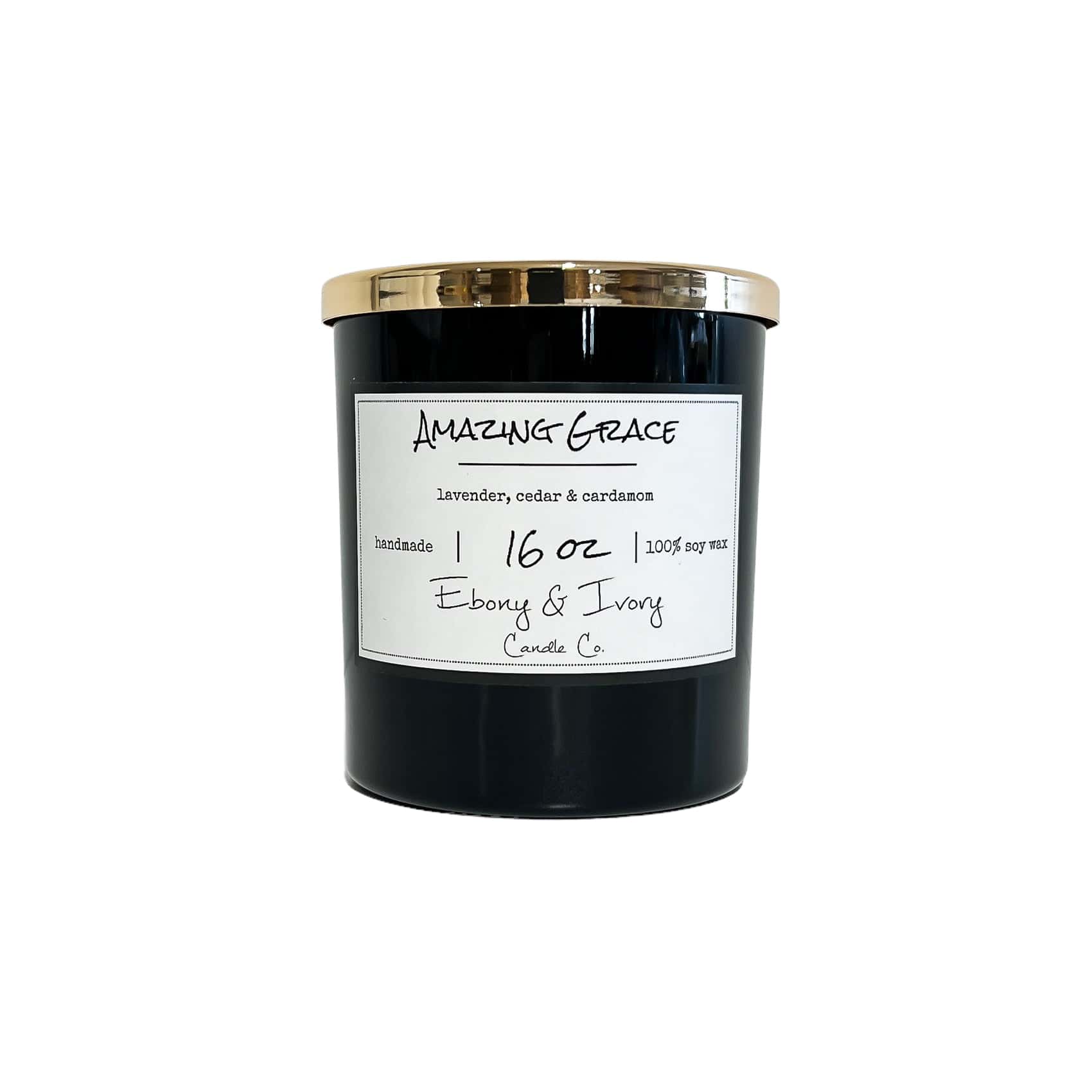 A black 16oz jar soy candle with a gold lid and a white label named Amazing Grace on a white background, made by Ebony & Ivory Candle Co in Lethbridge, Alberta, Canada