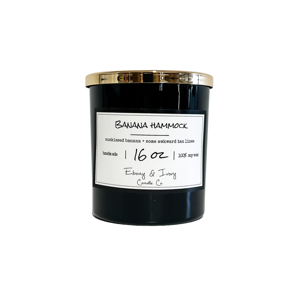 Black, sixteen ounce, Banana and vanilla scented soy wax candle with a white label that reads Banana Hammock