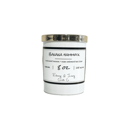 white, eight ounce, Banana and vanilla scented soy wax candle with a white label that reads Banana Hammock