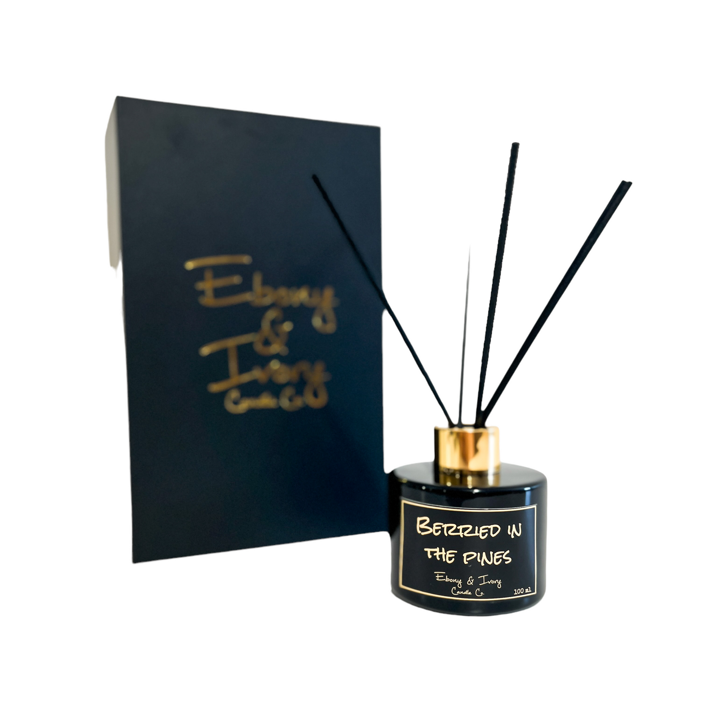 Black one hundred milliliters, blue spruce and huckleberry scented reed diffuser with a gold lid and a black label that reads Berried in the Pines