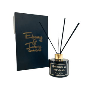 Black, one hundred milliliter, frozen pine and huckle berry scented reed diffuser with a gold lid and a black label that reads Berried in the Pines