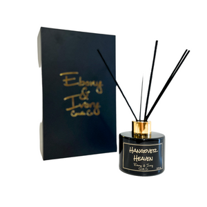 Black, one hundred milliliter, white tea, ginger, peach, and chardonnay scented reed diffuser with a gold lid and a black label that reads Hangover Heaven