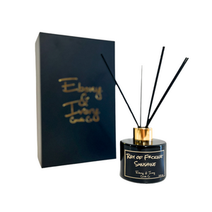 Black, one hundred milliliter, sun tan lotion scented reed diffuser with a gold lid and a black label that reads Ray of fucking sunshine