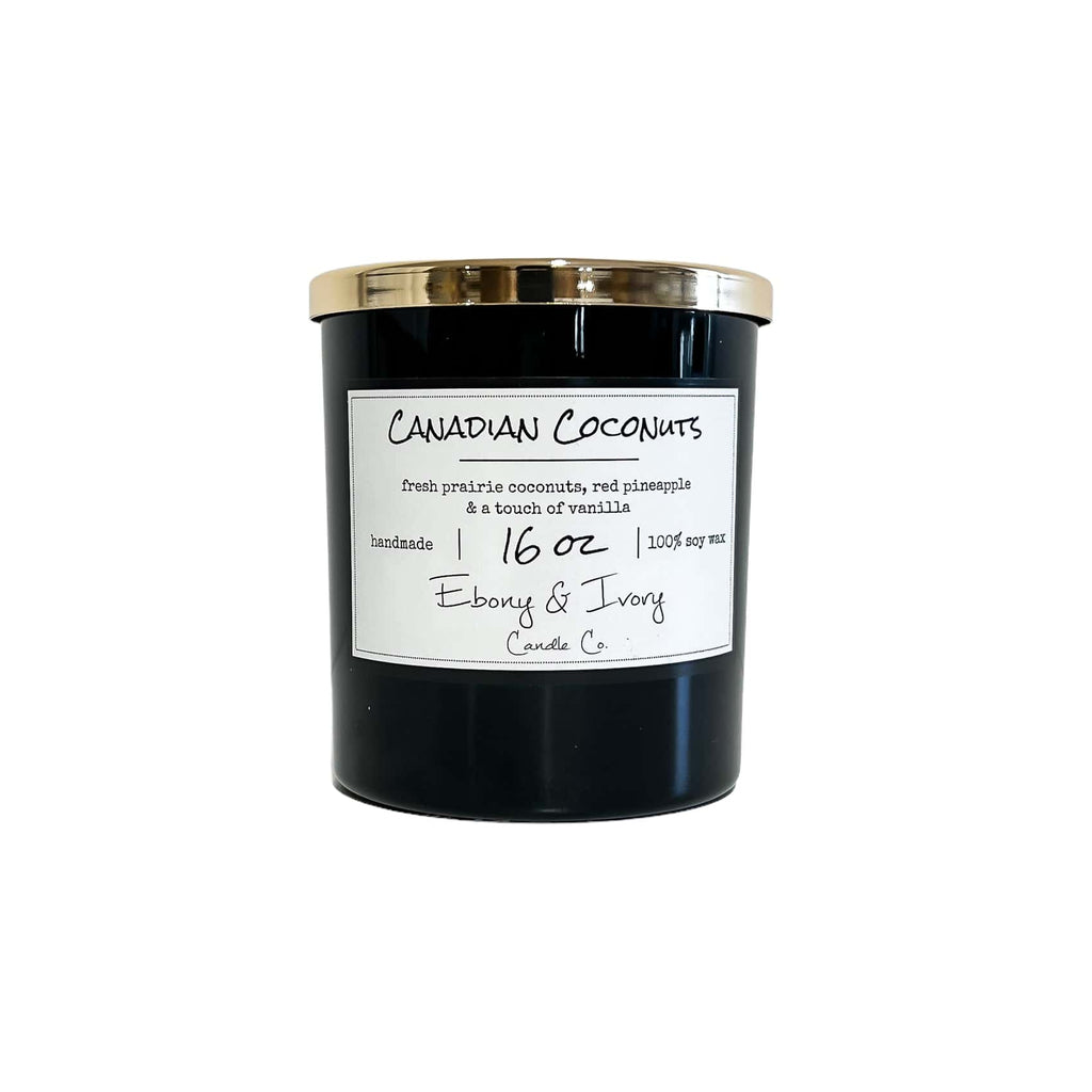 Black, sixteen ounce, coconut, pineapple, and vanilla scented soy wax candle with a gold lid and a white label that reads Canadian Coconuts