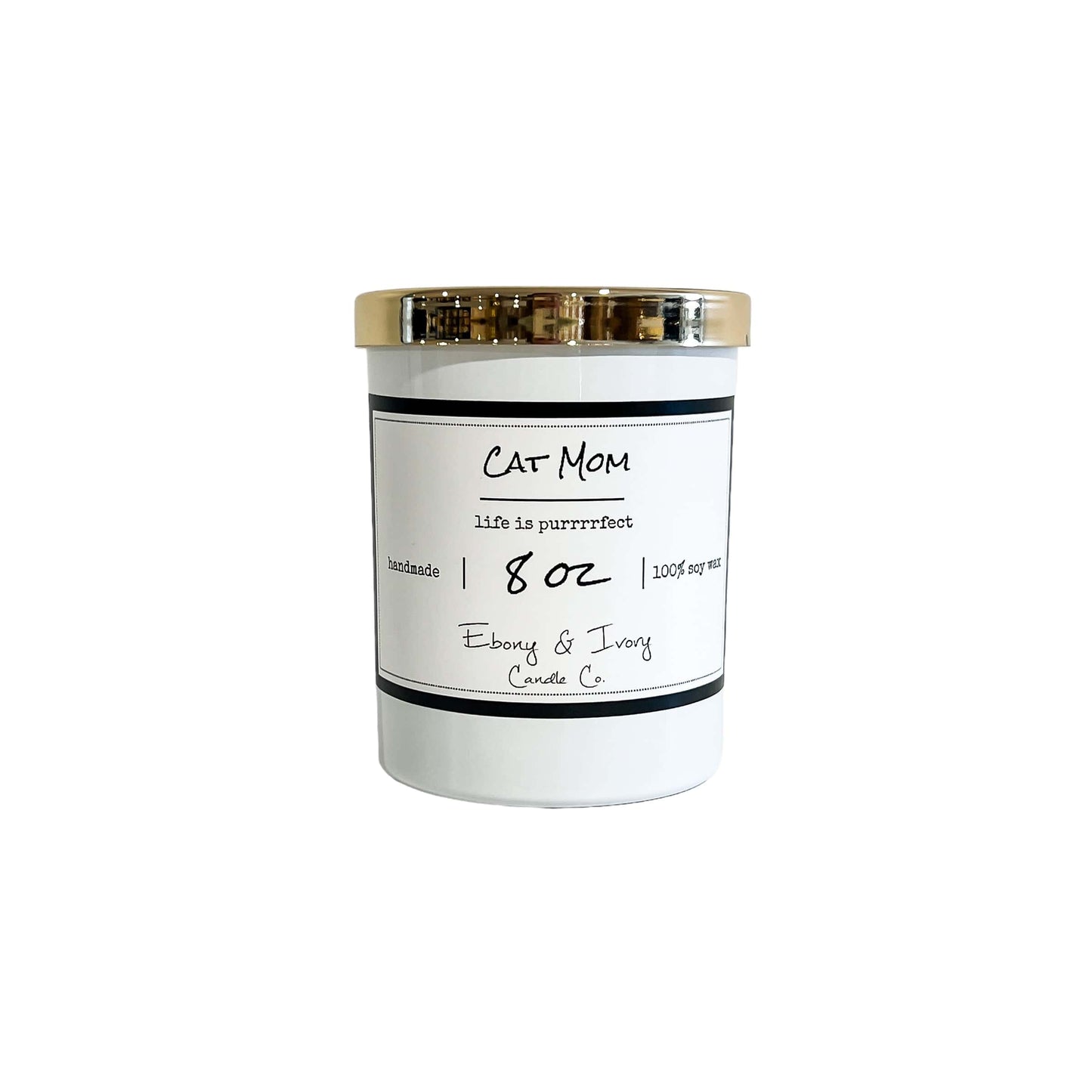 A white 8oz soy candle with a gold lid, labelled "Cat Mom" made by ebony & ivory candle co in Lethbridge Alberta canada