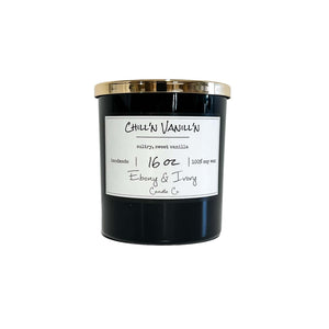Black, sixteen ounces, sweet vanilla scented soy wax candle with a gold lid and a white label that reads Chill'n Vanill'n
