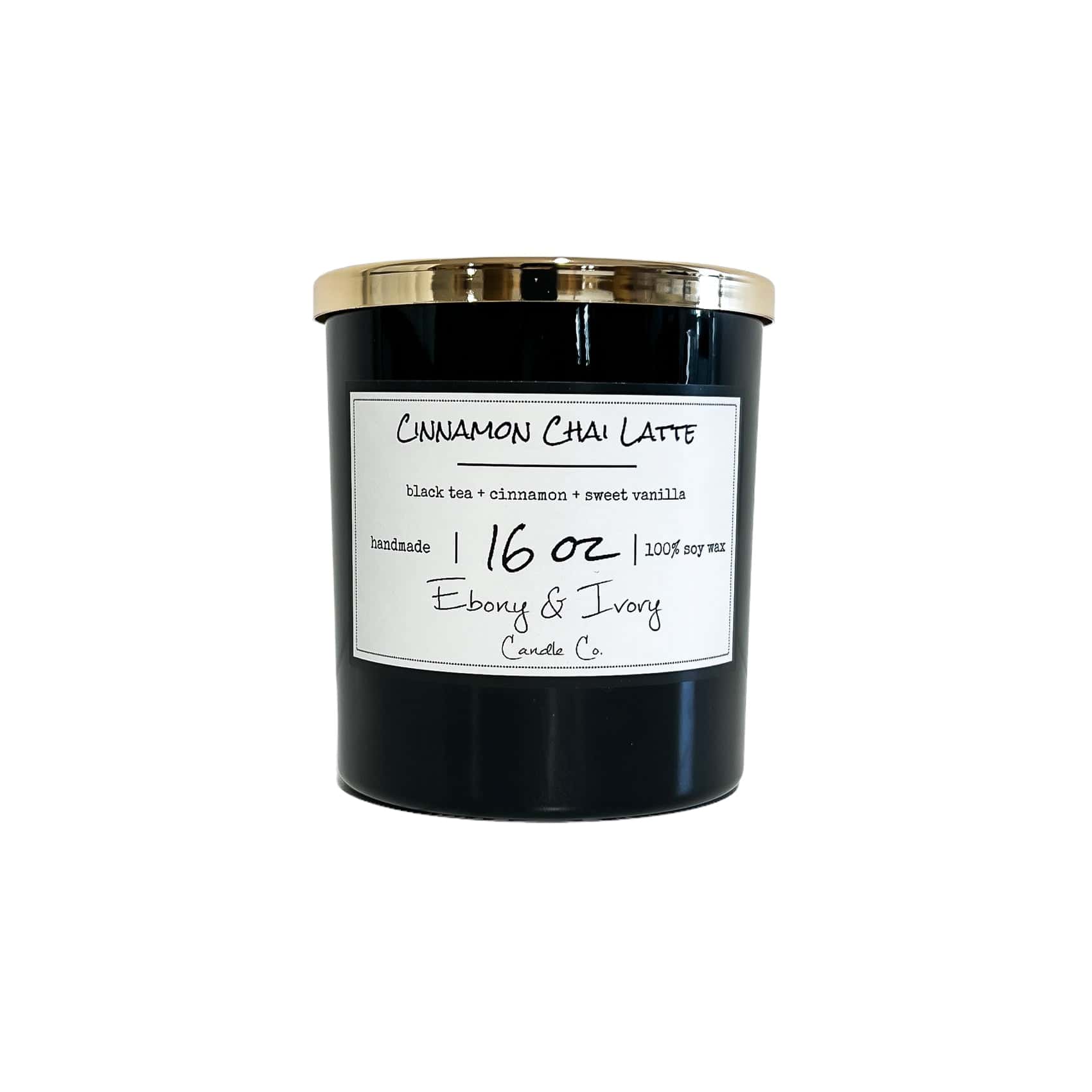 Black, sixteen ounces, black tea, cinnamon, and vanilla scented soy wax candle with a gold lid and a white label that reads Cinnamon Chai Latte