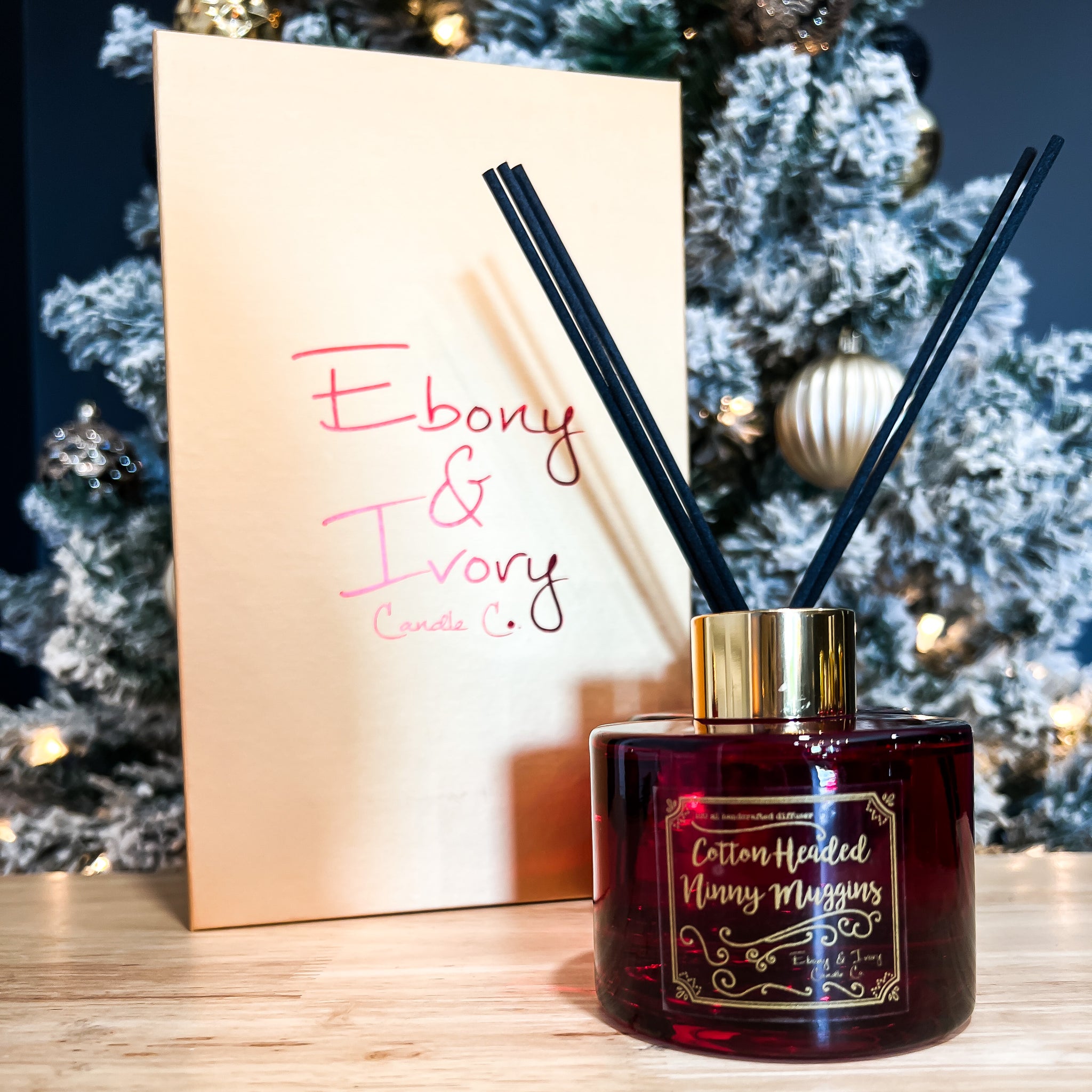 Red, one hundred milliliter, sugar cookie scented reed diffuser with a gold lid and label