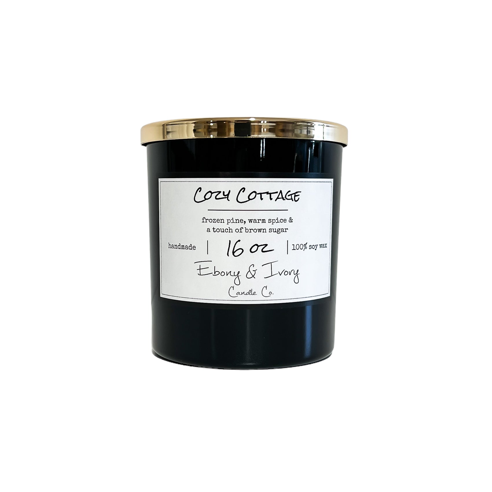 Black, sixteen ounces, frozen pine, warm spice, and brown sugar scented soy wax candle with a gold lid and a white label that reads Cozy Cottage