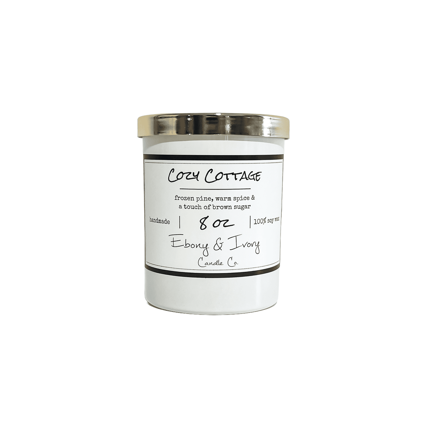 White, eight ounces, frozen pine, warm spice, and brown sugar scented soy wax candle with a gold lid and a white label that reads Cozy Cottage