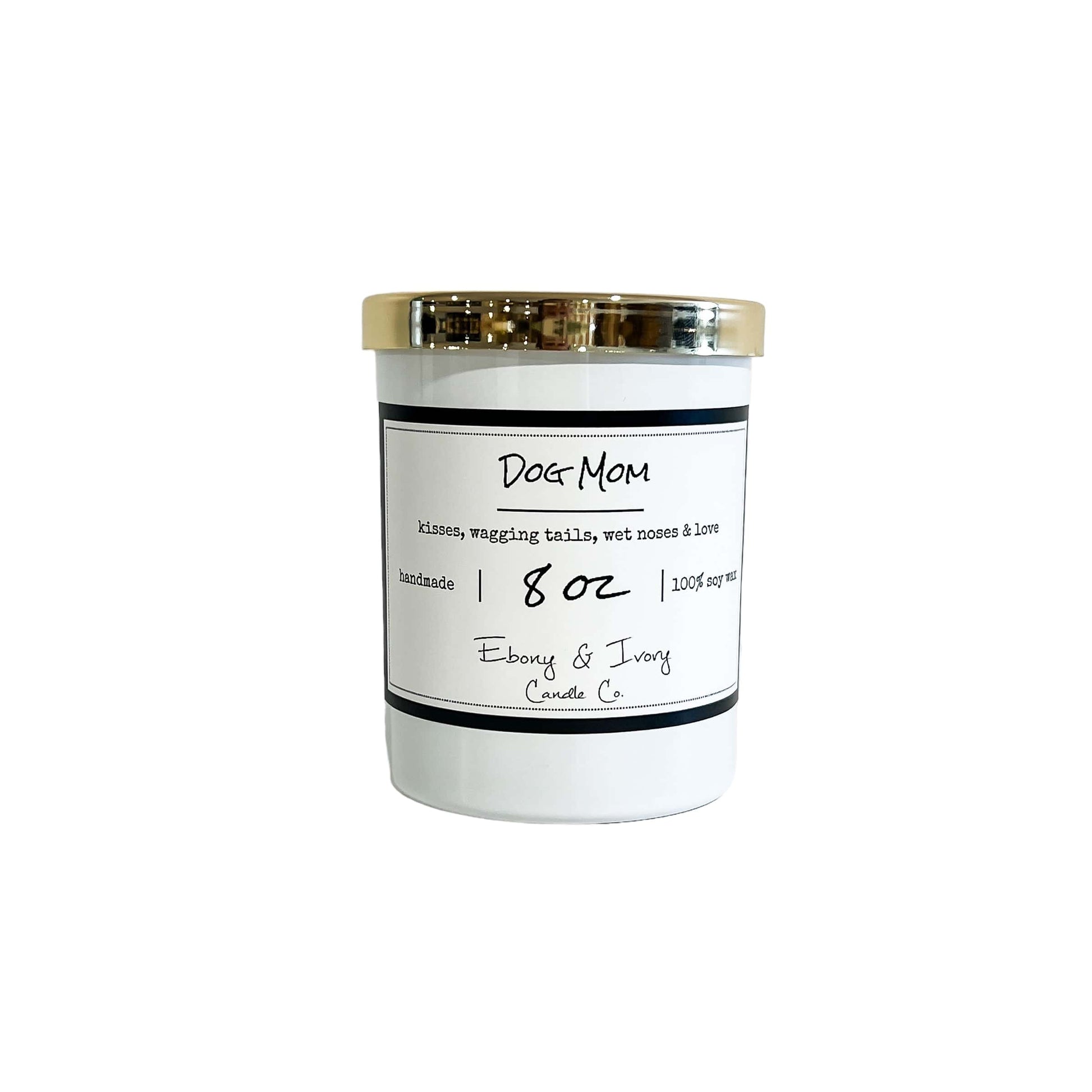 A white 8oz soy candle with a gold lid, labelled "Dog Mom" made by ebony & ivory candle co in lethbridge alberta canada