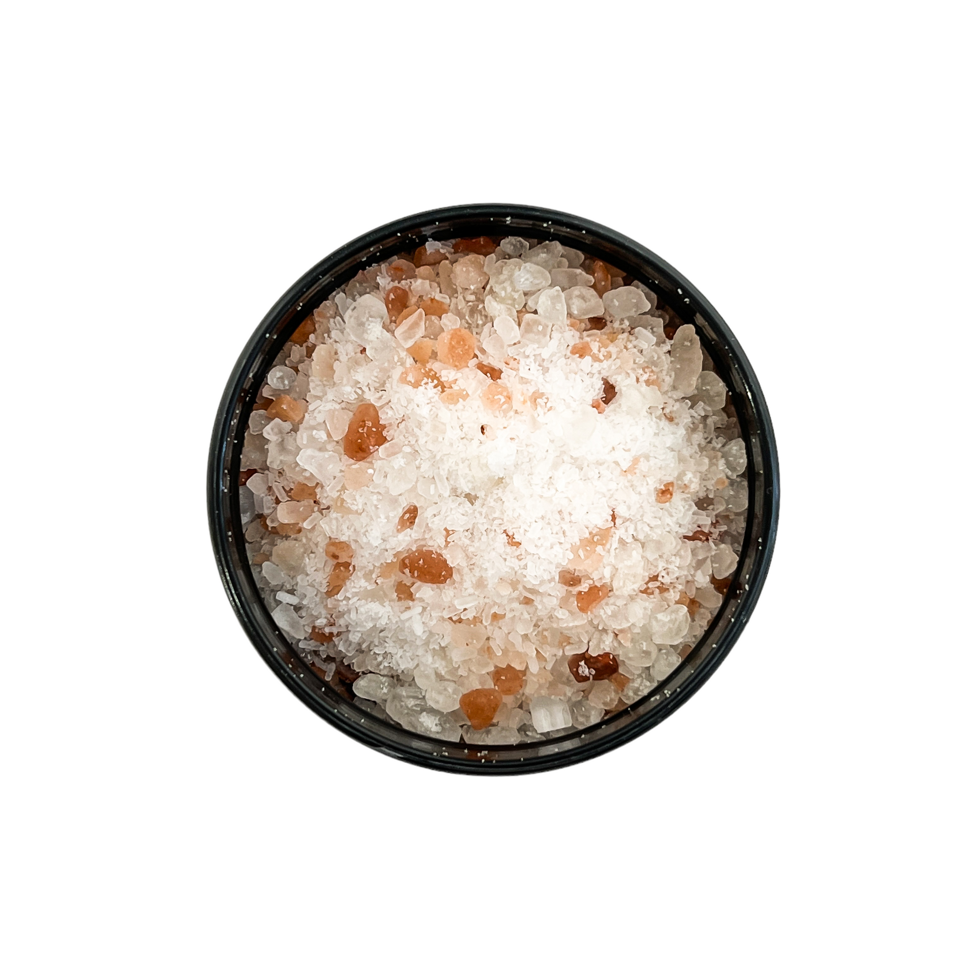 Black container with a white label that reads "elixir" and is filled with pink Himalayan salt, dead sea salt, epsom salt, and peppermint essential oils.