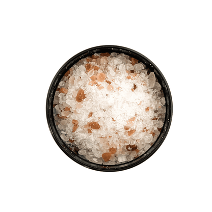 Black container with a white label that reads "elixir" and is filled with pink Himalayan salt, dead sea salt, epsom salt, and peppermint essential oils.