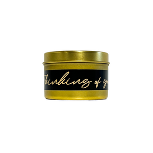 gold four ounces, pink salt and water lily scented soy wax candle with a gold and a black label that reads Thinking of you