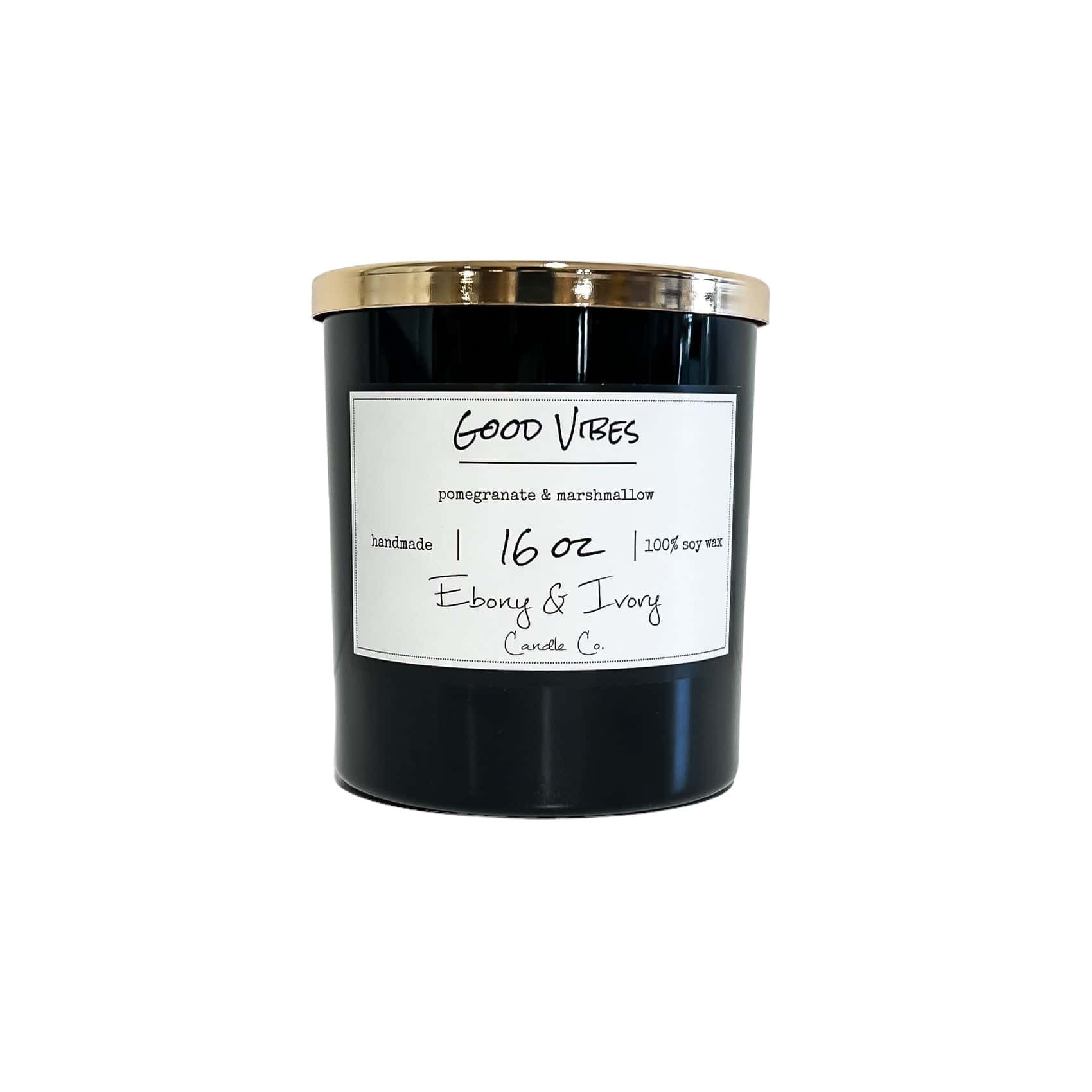 Black sixteen ounce, Pomegranate and Marshmallow scented soy wax candle with a gold lid and a white label that reads Good Vibes