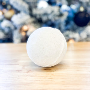 white holiday scented bath bomb with gold glitter