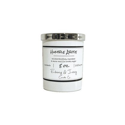 White, eight ounce, snickerdoodle, cupcake, vanilla, and brown sugar scented soy wax candle with a gold lid and a white label that reads Humble Abode