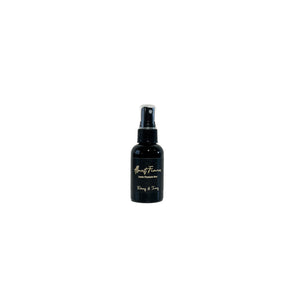 black two fluid ounces, citrus, jasmine, and woodsy scented fragrance body and room spray with a black label that reads Almost Famous