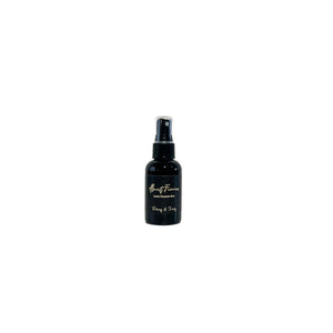 black two fluid ounces, citrus, jasmine, and woodsy scented fragrance body and room spray with a black label that reads Almost Famous