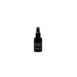 Black, two fluid ounce, white tea, ginger, peach, and chardonnay scented fragrance spray with a black label that reads Hangover Heaven