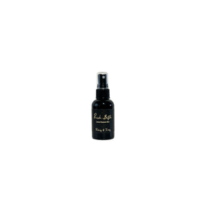 Black, two fluid ounce, oud, bergamot, and citrus scented fragrance spray with a black label that reads Rich Bitch