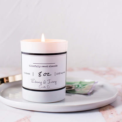 No name soy candle in an 8oz white jar sitting on a clean white ray with money in the background, made by Ebony & Ivory Candle Co in Lethbridge, Alberta, Canada