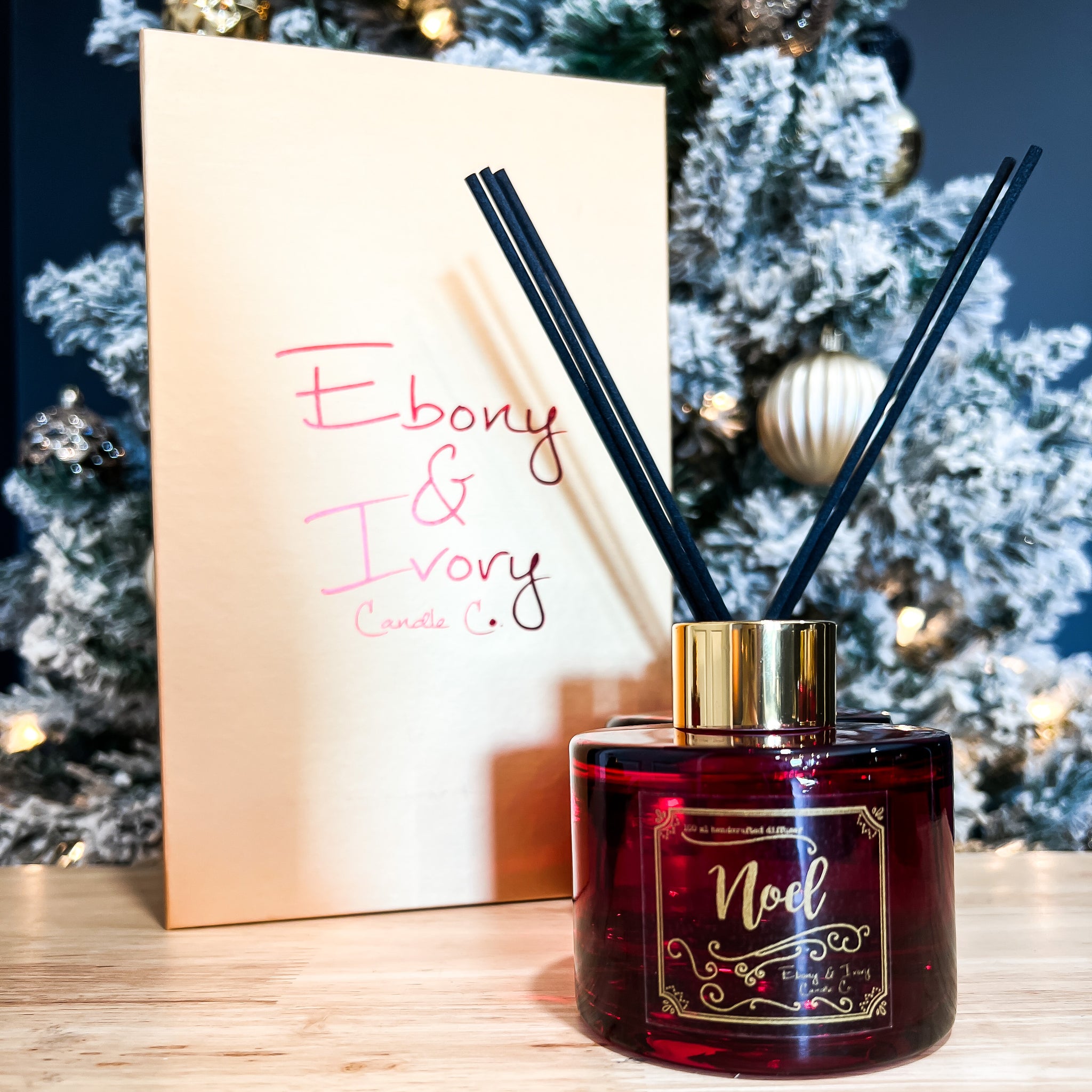 Red, one hundred milliliter, Pine, fir, holiday spices, clove, nutmeg, citrus, orange scented reed diffuser with a gold lid and label