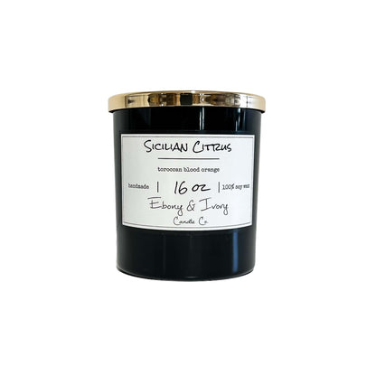 A black jar 16oz soy candle with a gold lid and a white label named Sicilian Citrus, on a white background, made by Ebony & Ivory Candle Co in Lethbridge, Alberta, Canada