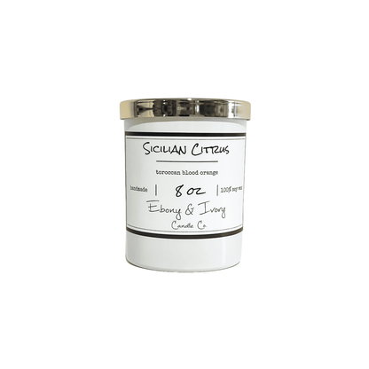 A white jar 8oz soy candle with a gold lid and a white label named Sicilian Citrus, on a white background, made by Ebony & Ivory Candle Co in Lethbridge, Alberta, Canada