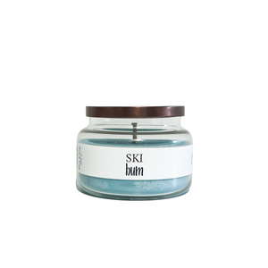 Clear glass, sixteen ounce, peppermint and vanilla, scented, blue coloured soy wax candle with a bronze lid and a white label that reads Ski Bum